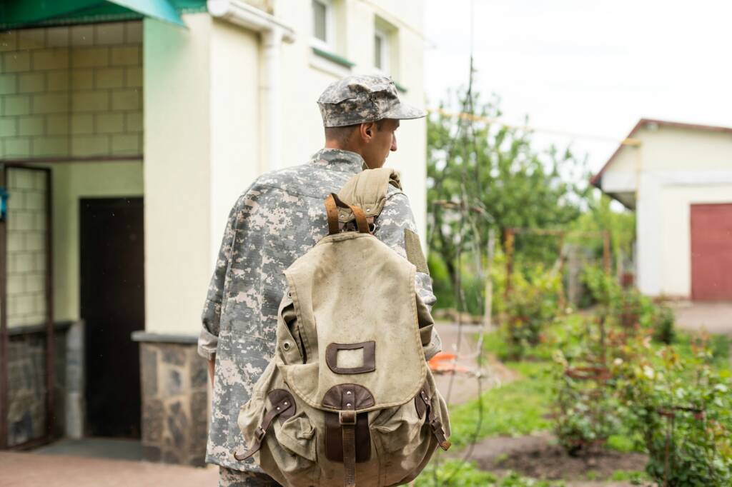 Young caucasian man wearing camouflage army uniform