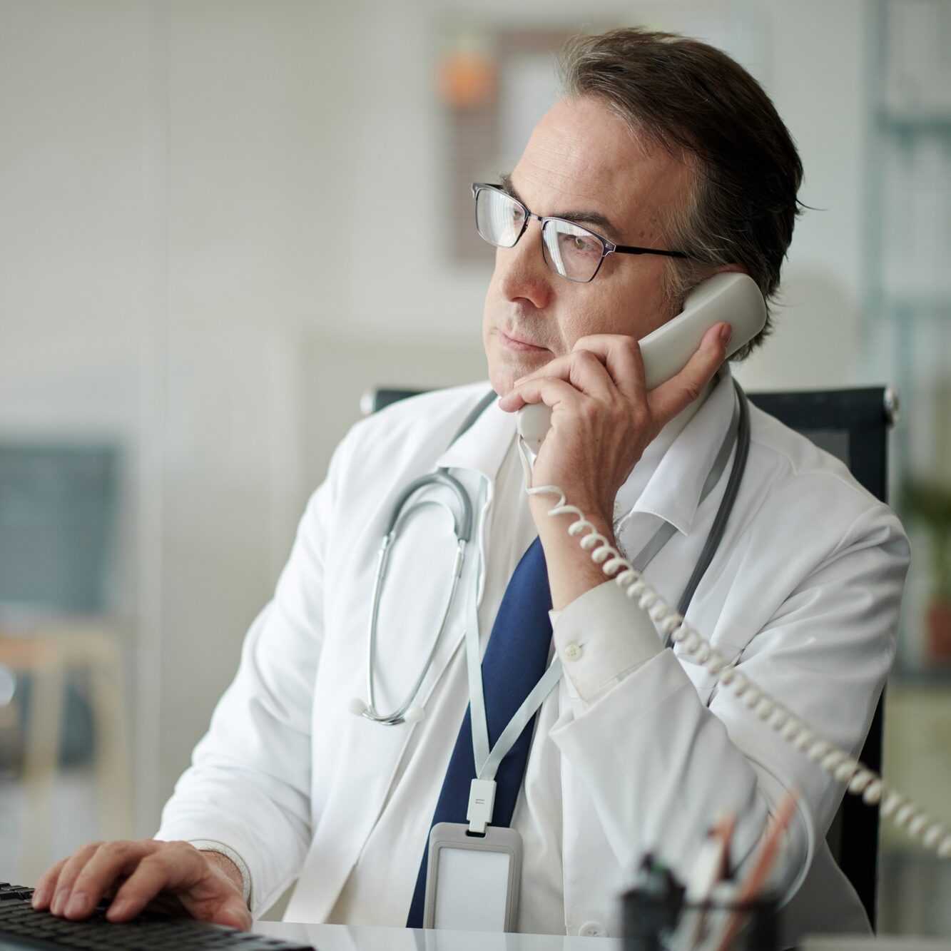 Doctor Answering Phone Call