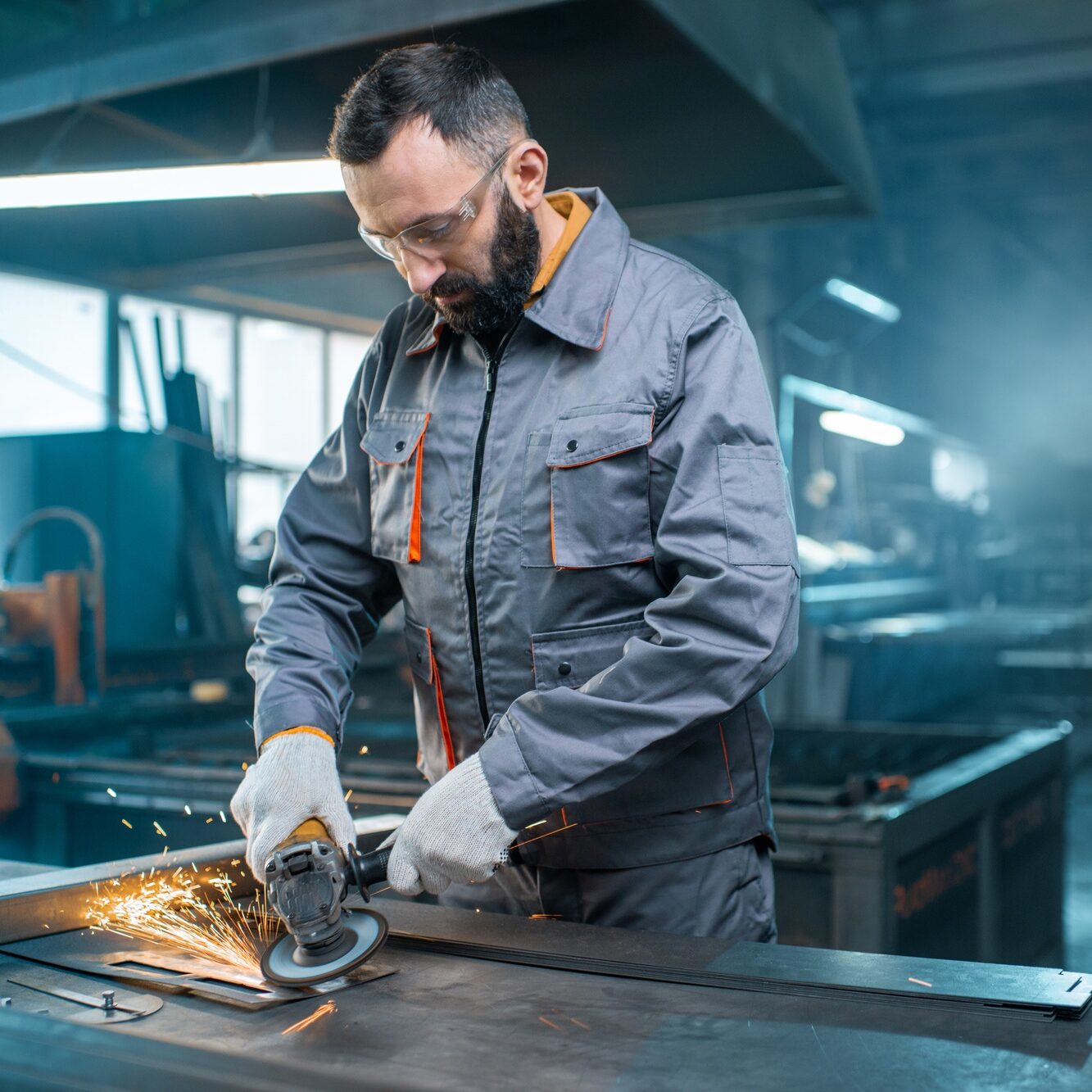 Metal industry worker at factory in work wear