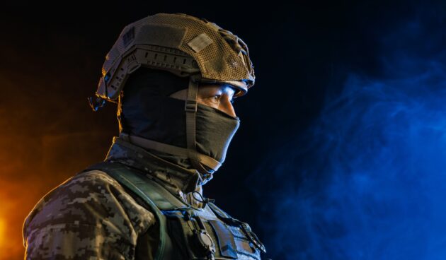 Portrait of a Tactical Soldier in Combat Gear against an Intense Orange and Blue Background